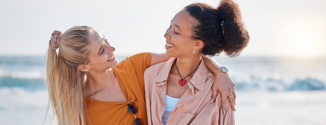Zwei Frauen umarmen sich am Meer bei Worthing