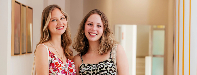 Zwei Mädchen stehen im Flur der Sprachschule in Sevilla